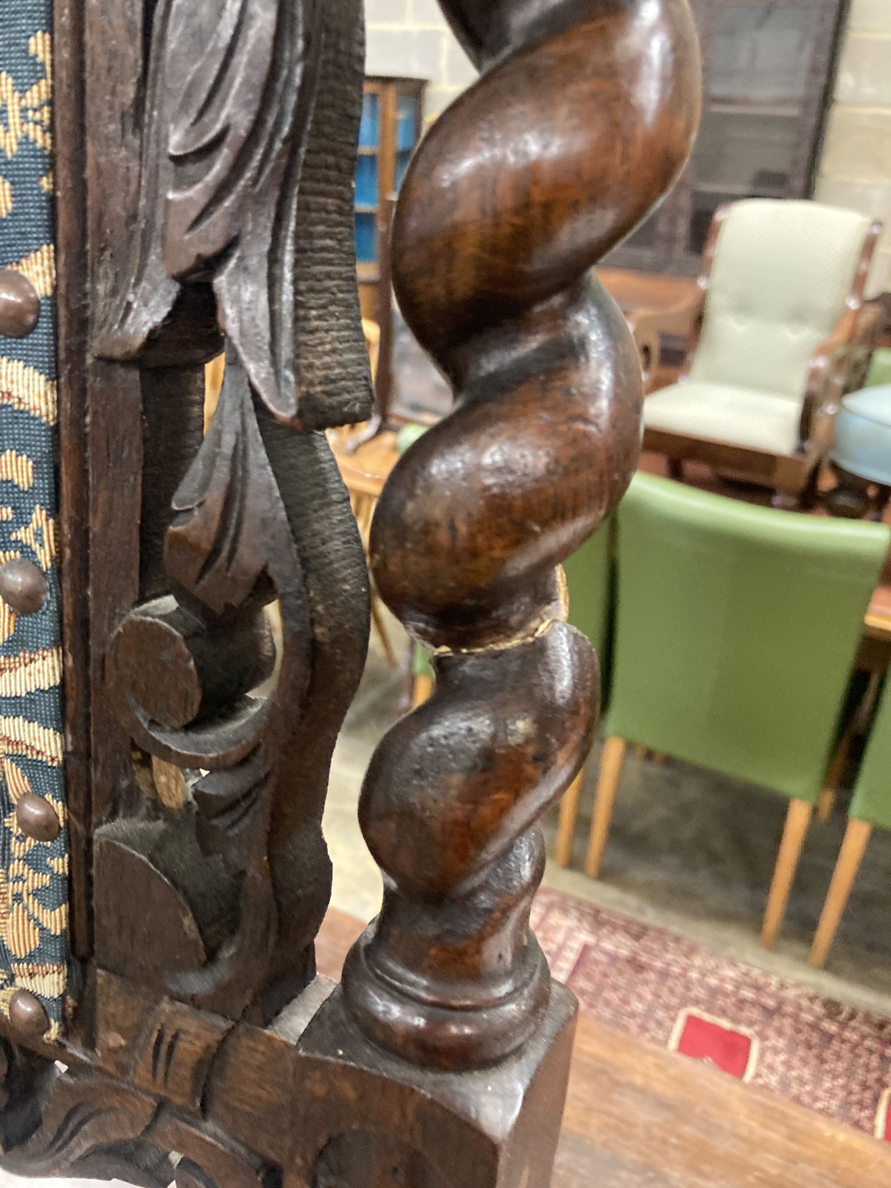 A pair of late 19th century Flemish carved oak panel backed dining chairs